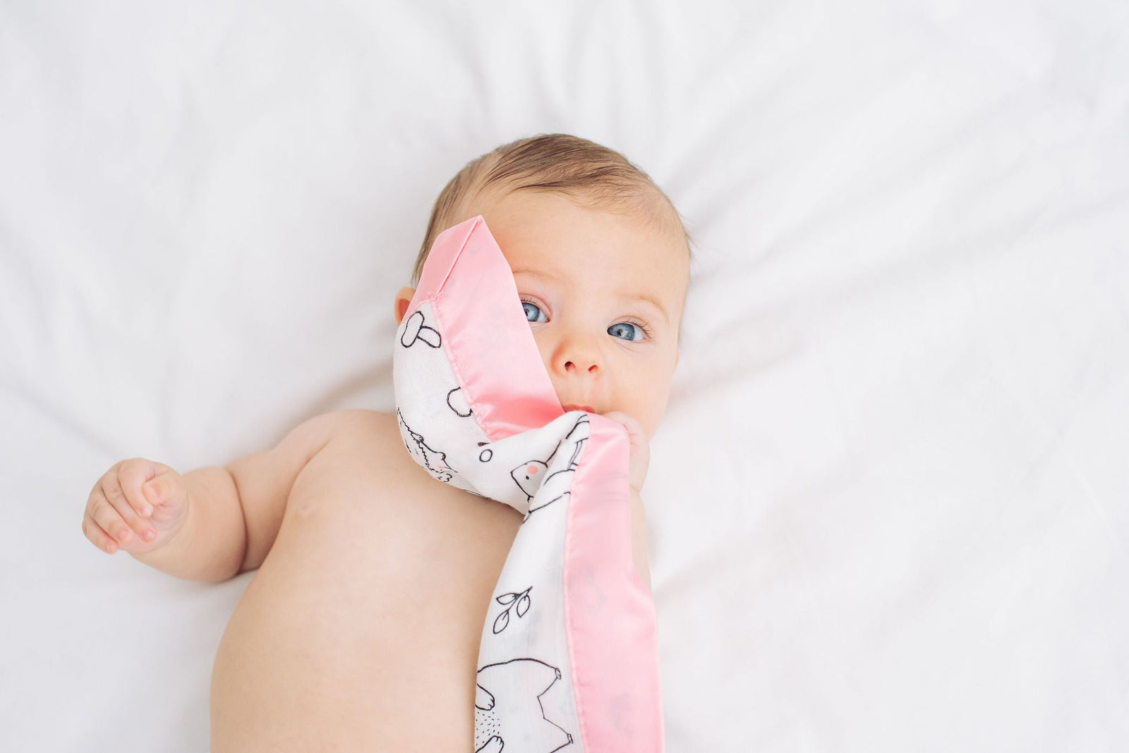 baby sleeping safely in cot with Bullabaloo satin edge muslin comforter